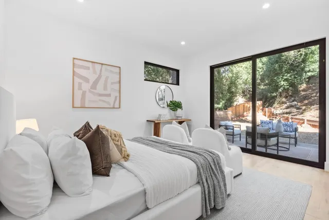 a bedroom with a large bed and a large window