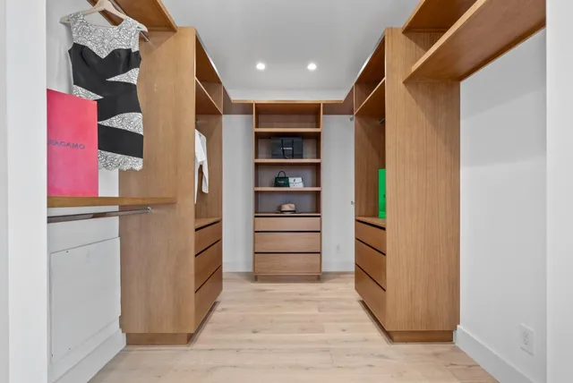 a view of walk in closet with empty racks