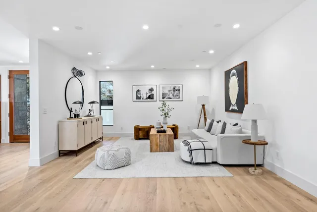 a living room with furniture and wooden floor