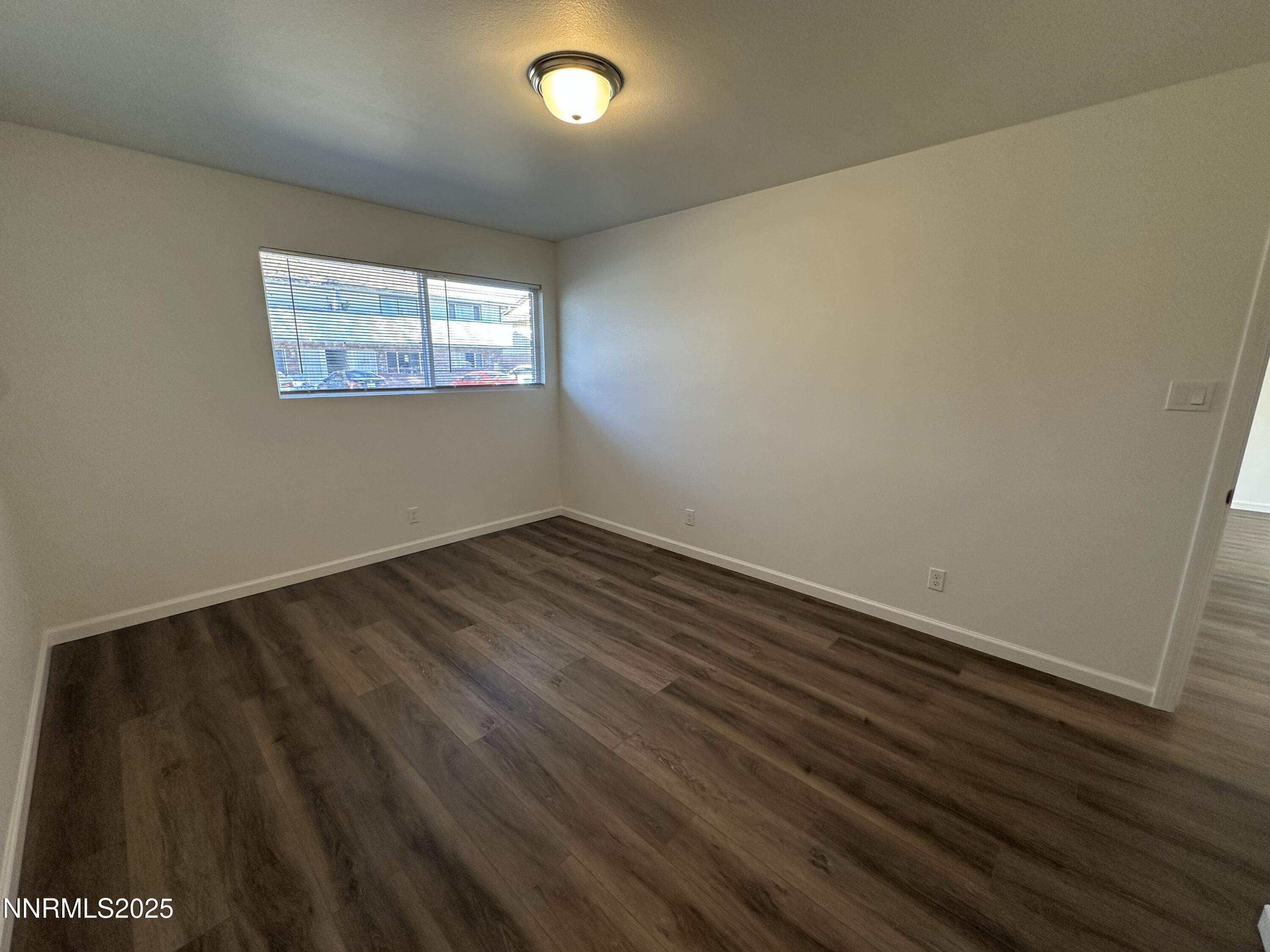 2370 Orange Lane Reno, NV 89502 - Photo 11 of 16 an empty room with wooden floor and windows