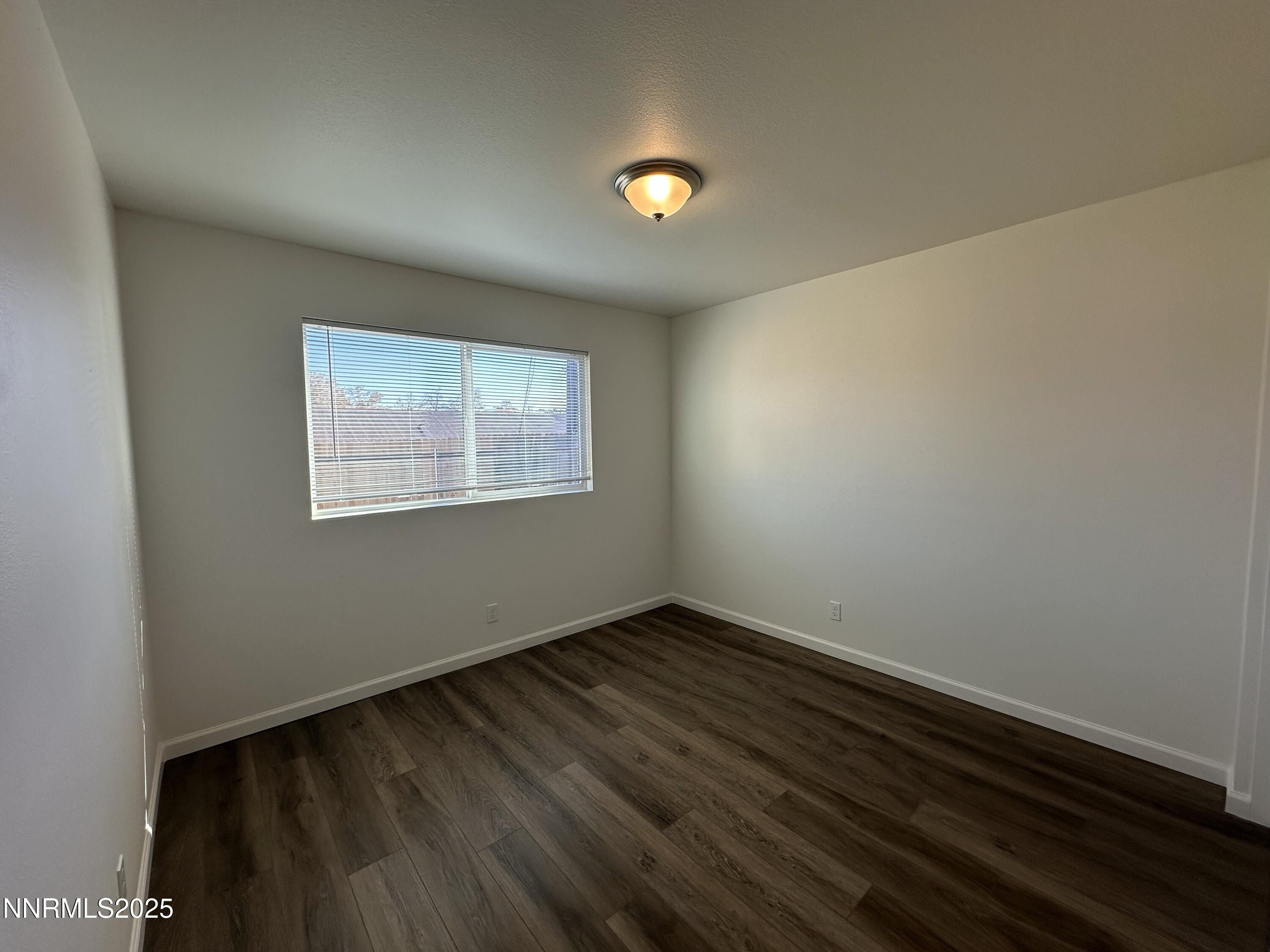 2370 Orange Lane Reno, NV 89502 - Photo 12 of 16 a view of an empty room with wooden floor and a window