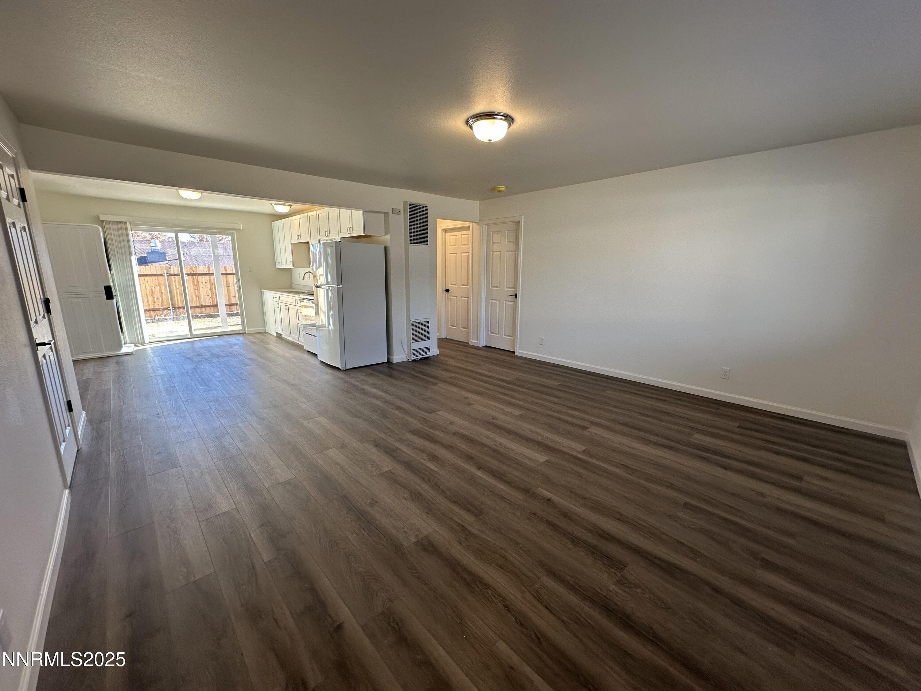 2370 Orange Lane Reno, NV 89502 - Photo 4 of 16 a view of an empty room with wooden floor and a window