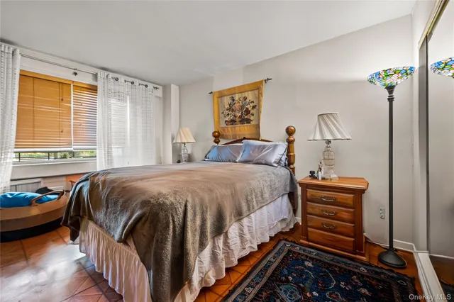 a bed sitting in a bedroom next to a window
