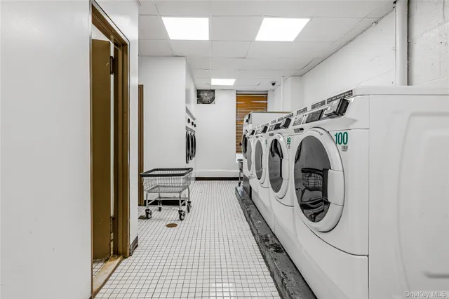 a view of a storage and utility room with washer and dryer