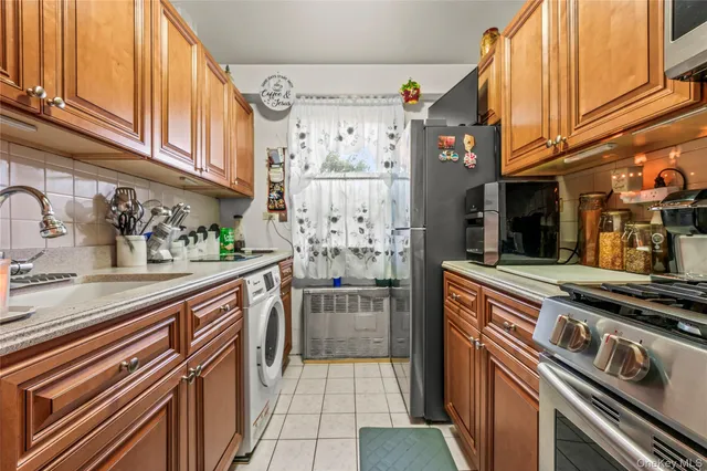 a kitchen with stainless steel appliances granite countertop a refrigerator and a stove
