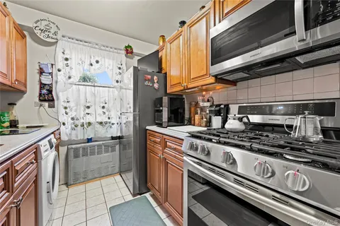 a kitchen with stainless steel appliances granite countertop a stove and a refrigerator