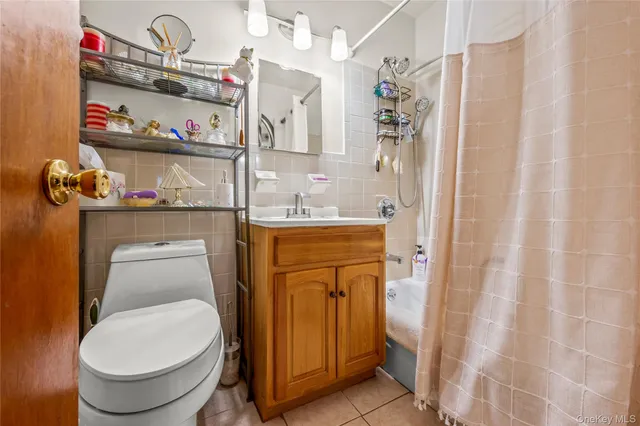 a bathroom with a sink a toilet and shower curtain