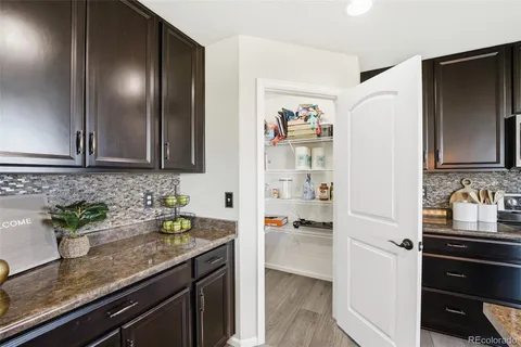 a kitchen with stainless steel appliances granite countertop a sink and a refrigerator
