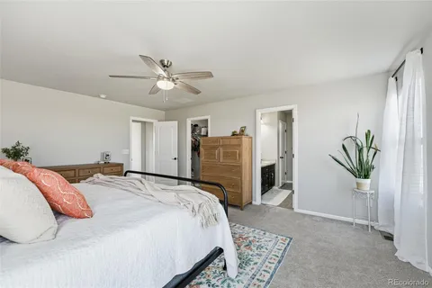 a bedroom with a bed dresser and a window