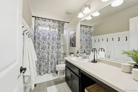 a bathroom with a sink and a mirror with toilet