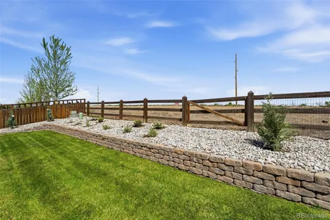 a view of a house with a yard and a patio