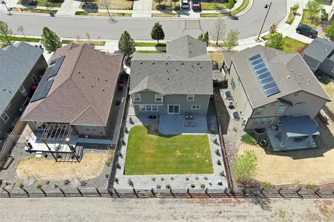 an aerial view of residential houses with outdoor space and ocean view