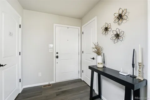 a view of a room with a table and wooden floor