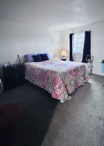 a bedroom with a bed and window