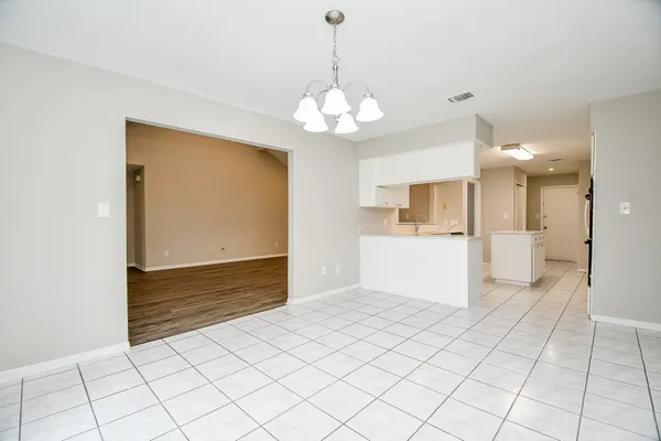 a view of an empty room with a kitchen
