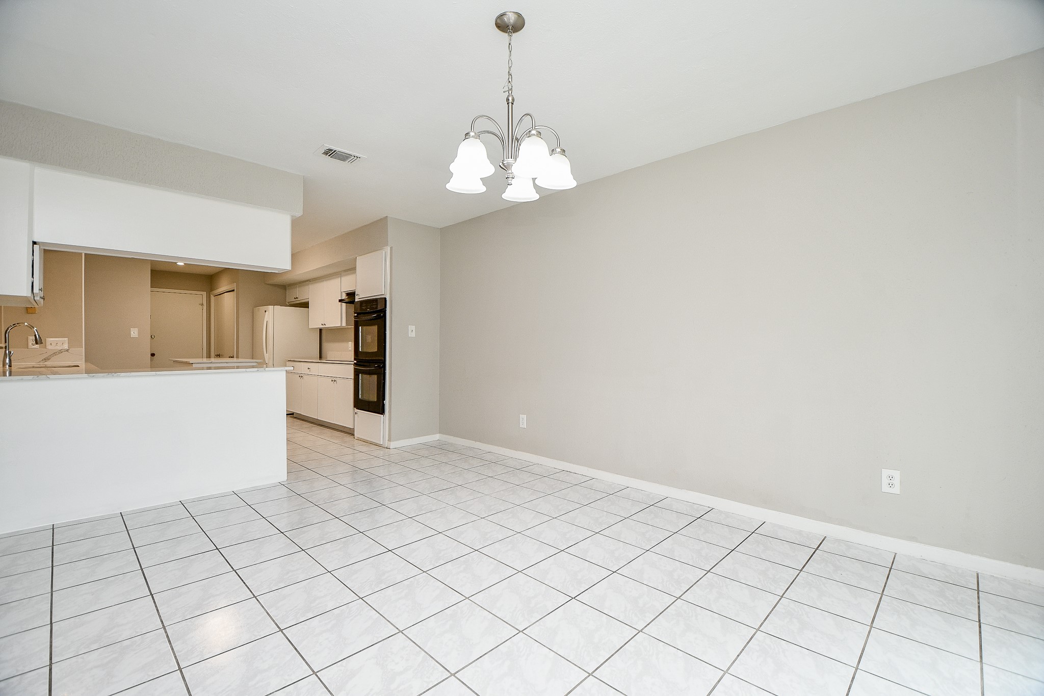 11411 Pepperdine Lane Houston, TX 77071 - Photo 13 of 31 a view of an empty room with a kitchen