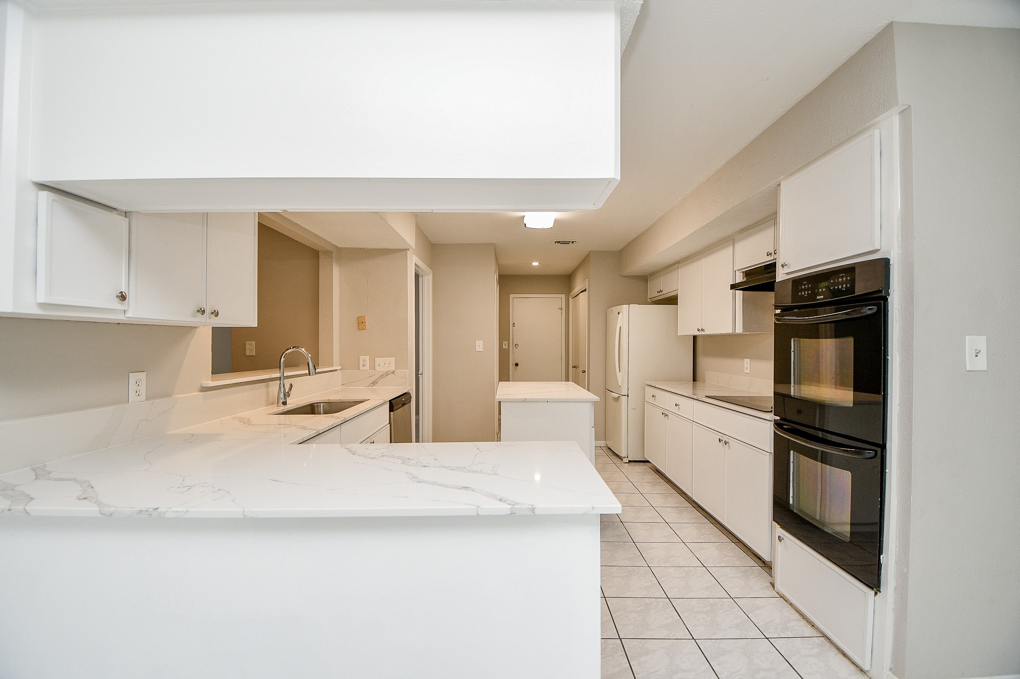 11411 Pepperdine Lane Houston, TX 77071 - Photo 14 of 31 a kitchen with stainless steel appliances kitchen island granite countertop a refrigerator and a sink
