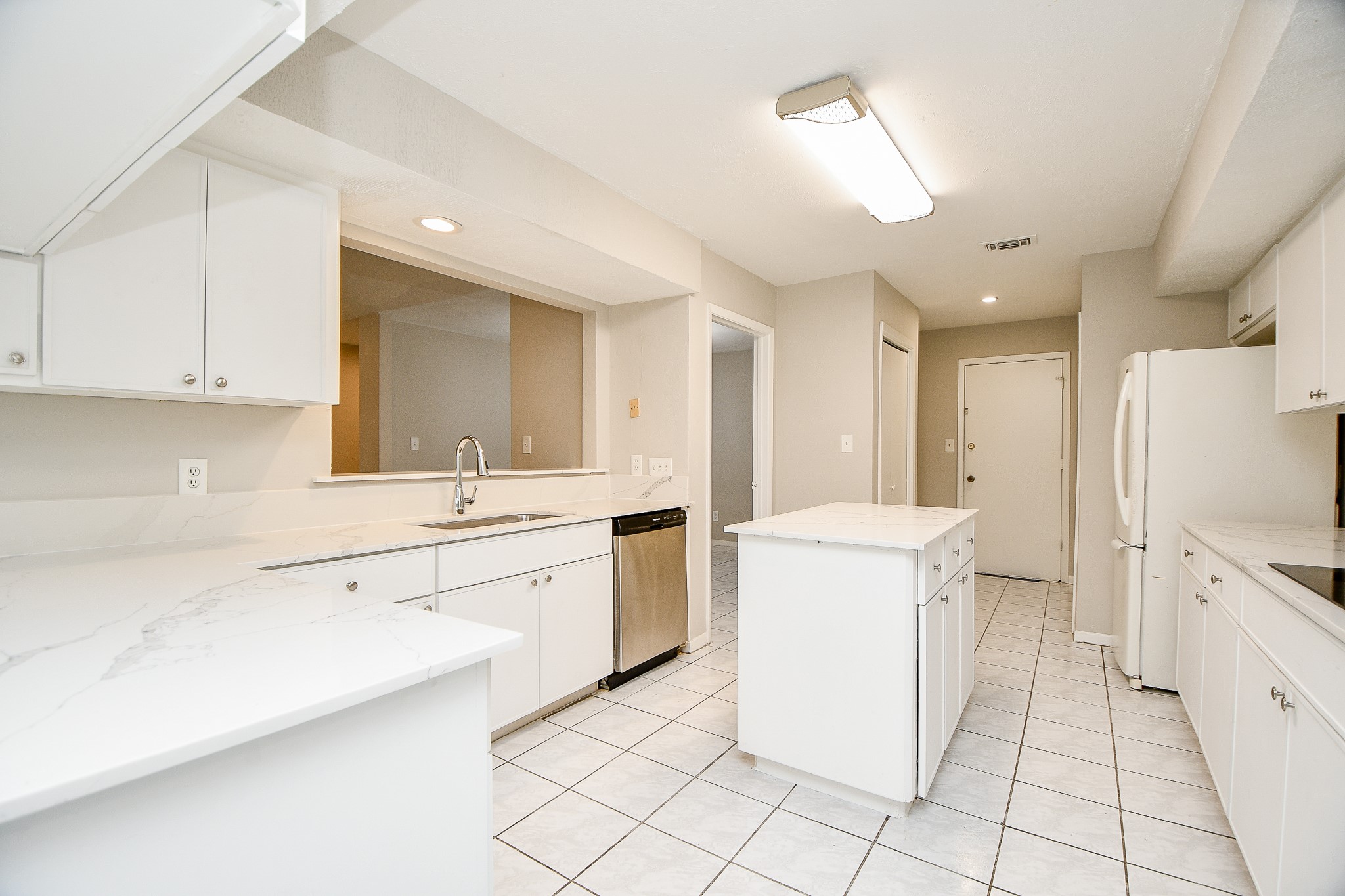 11411 Pepperdine Lane Houston, TX 77071 - Photo 15 of 31 a large white kitchen with a stove a sink a washer and dryer