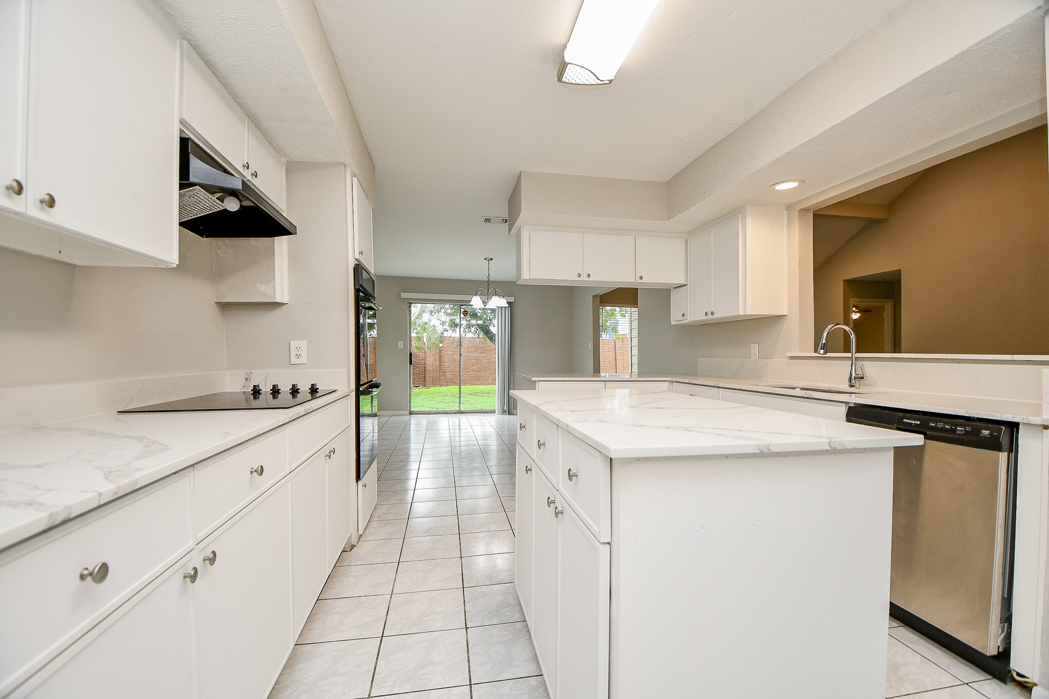 11411 Pepperdine Lane Houston, TX 77071 - Photo 19 of 31 a kitchen with a sink a stove a microwave and cabinets