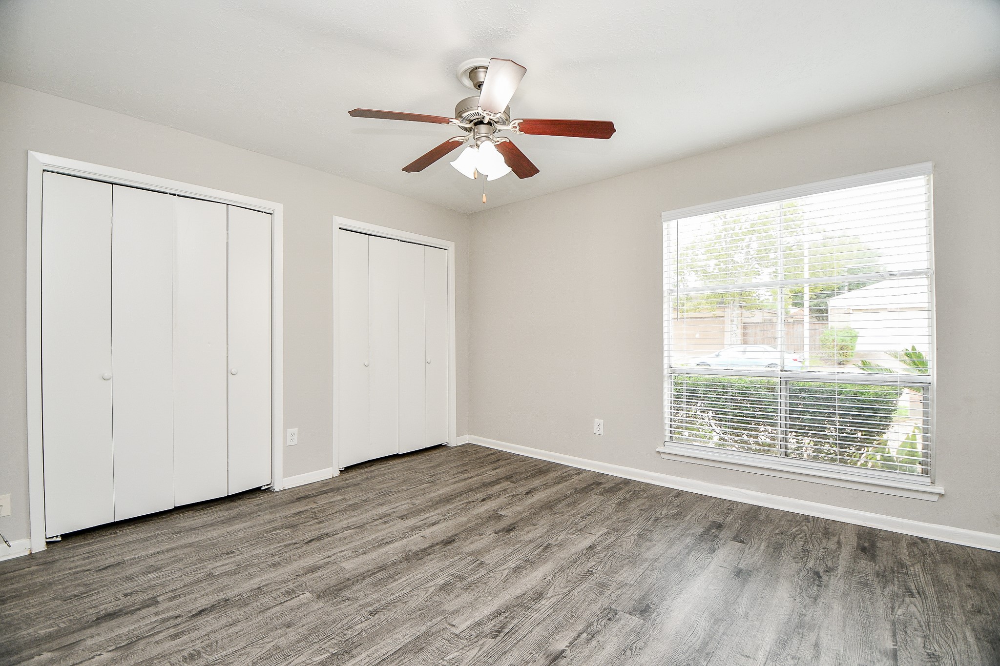 11411 Pepperdine Lane Houston, TX 77071 - Photo 22 of 31 a view of an empty room with wooden floor and a window