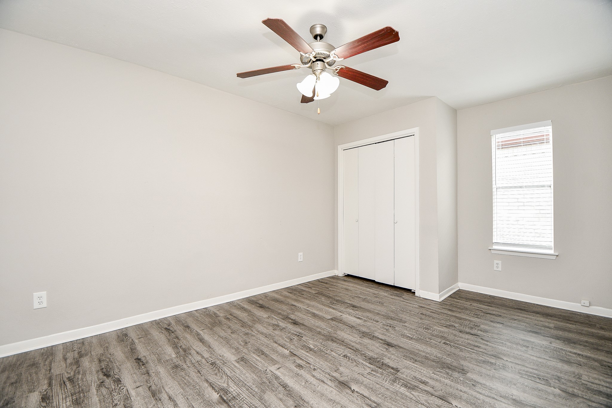 11411 Pepperdine Lane Houston, TX 77071 - Photo 24 of 31 an empty room with wooden floor ceiling fan and windows