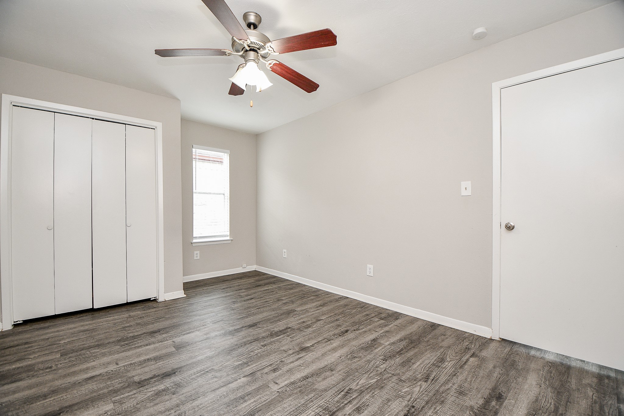 11411 Pepperdine Lane Houston, TX 77071 - Photo 25 of 31 an empty room with wooden floor ceiling fan and window