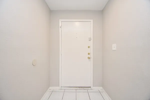an empty room with wooden floor and fireplace