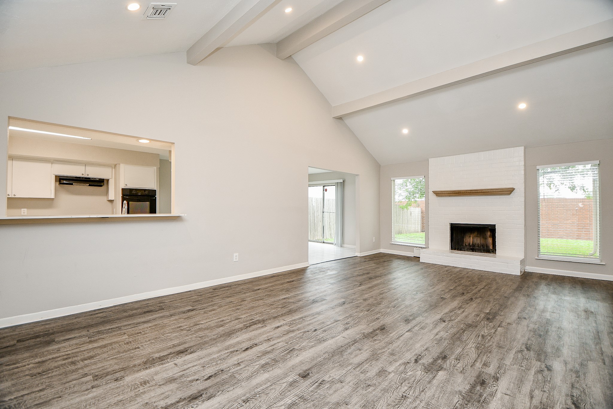 11411 Pepperdine Lane Houston, TX 77071 - Photo 6 of 31 an empty room with wooden floor and fireplace