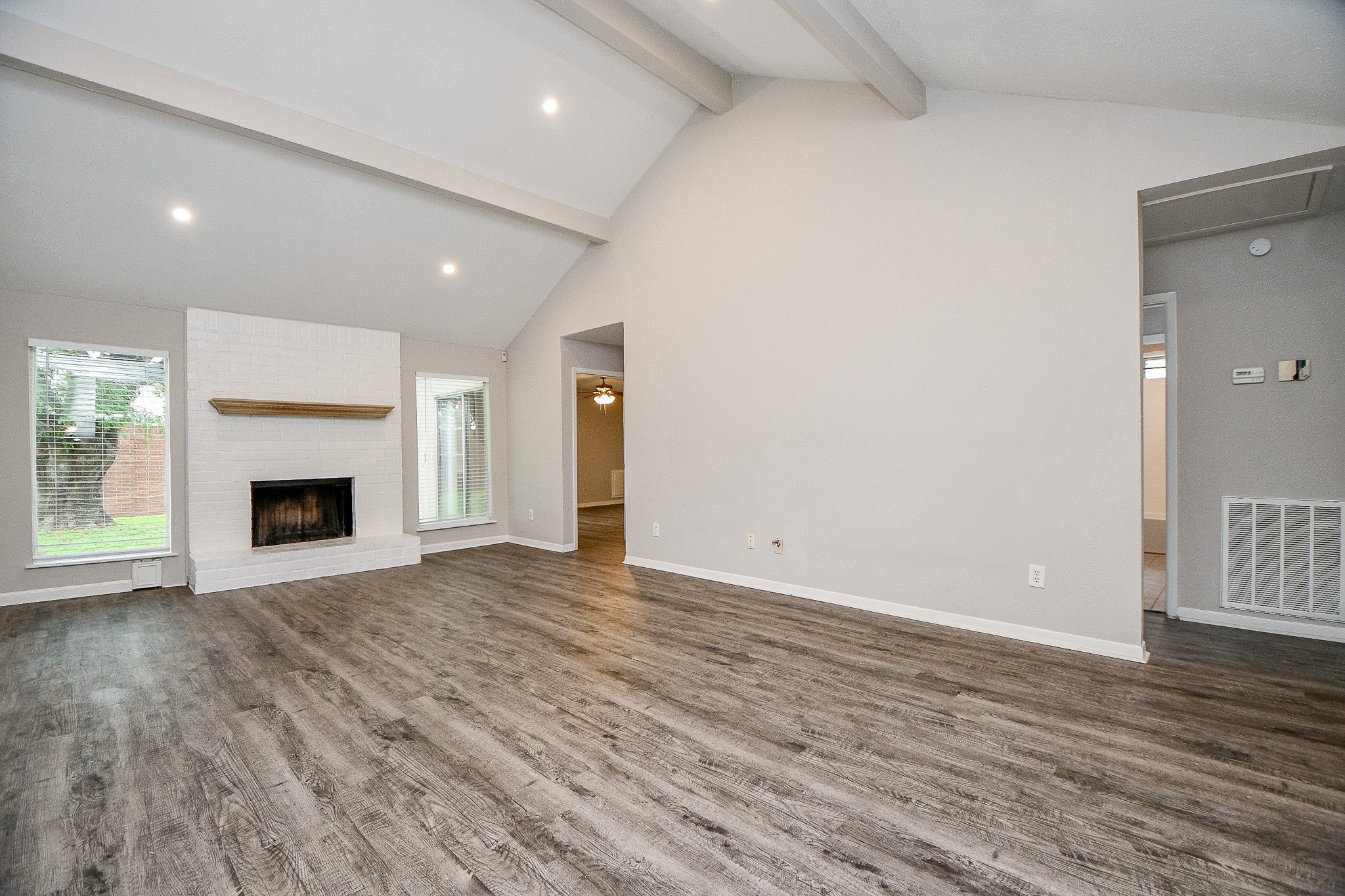 11411 Pepperdine Lane Houston, TX 77071 - Photo 7 of 31 an empty room with wooden floor and fireplace