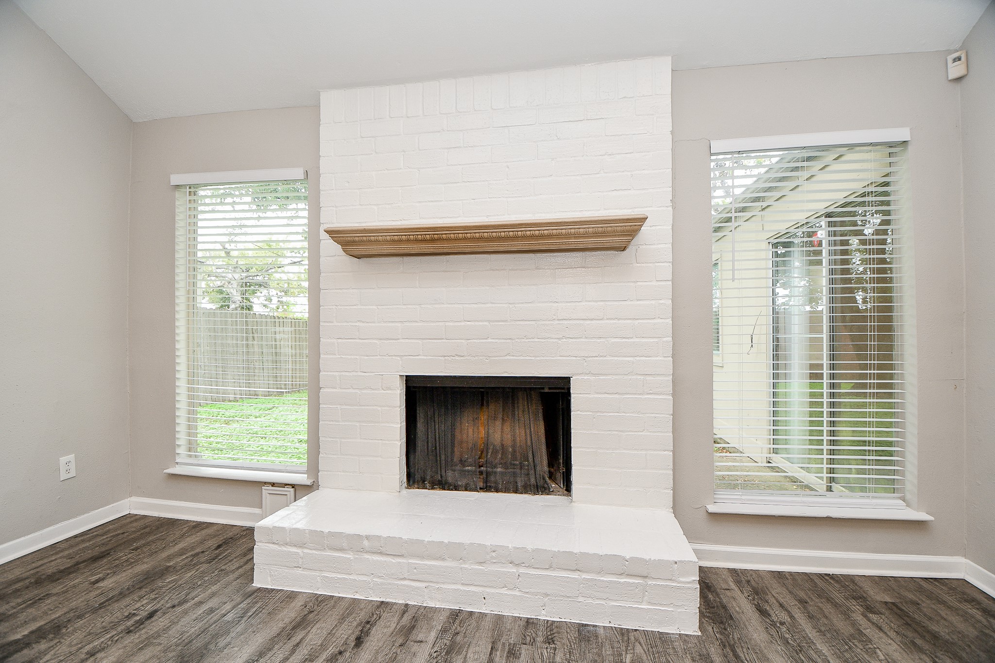 11411 Pepperdine Lane Houston, TX 77071 - Photo 9 of 31 a living room with a fireplace and a floor to ceiling window