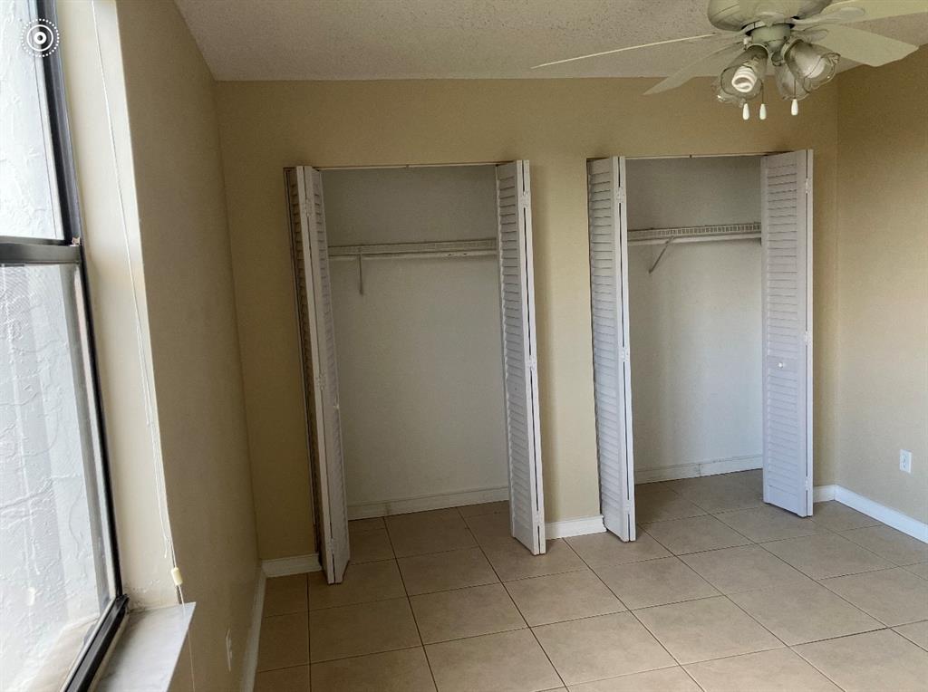 950 Lavers Circle, Unit F511 Delray Beach, FL 33444 - Photo 13 of 18 a view of an empty room with a mirror