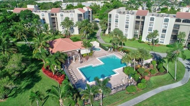 950 Lavers Circle, Unit F511 Delray Beach, FL 33444 - Photo 14 of 18 an aerial view of multiple houses with yard