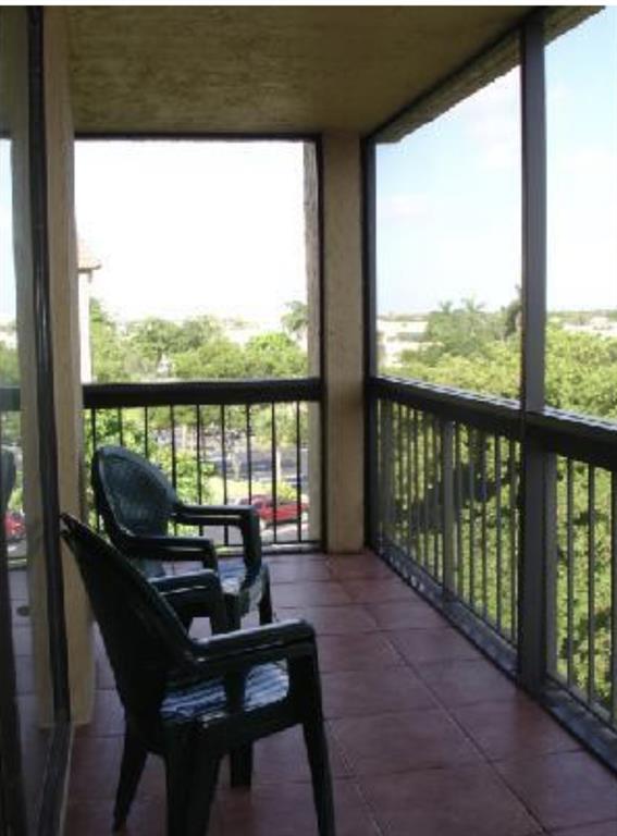 950 Lavers Circle, Unit F511 Delray Beach, FL 33444 - Photo 5 of 18 a view of a balcony with lake view and a floor to ceiling window