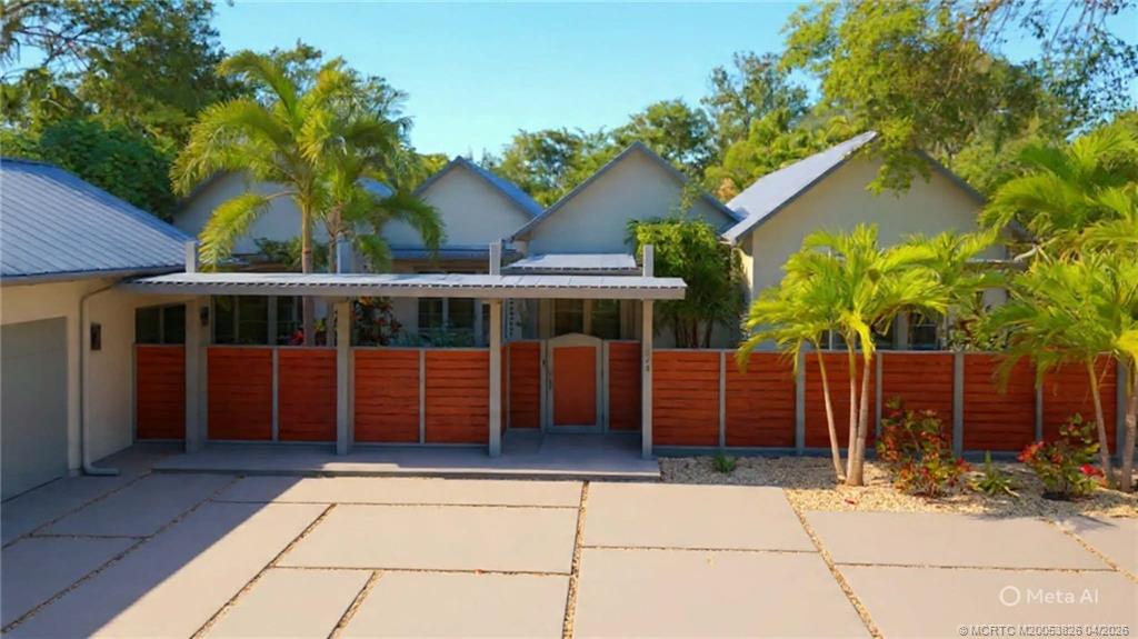 224 Southeast Wells Drive Stuart, FL 34996 - Photo 2 of 66 a front view of a house with a garden