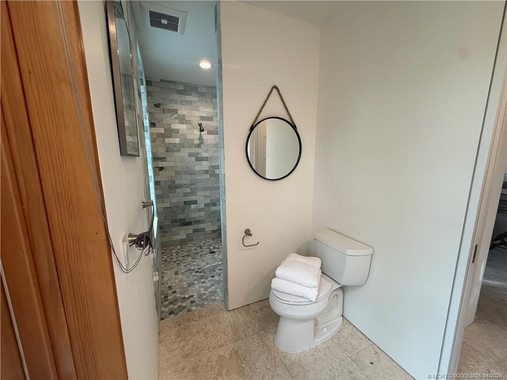 224 Southeast Wells Drive Stuart, FL 34996 - Photo 44 of 66 a bathroom with a toilet and a shower