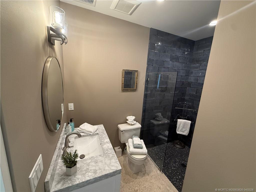 224 Southeast Wells Drive Stuart, FL 34996 - Photo 52 of 66 a bathroom with a sink and toilet