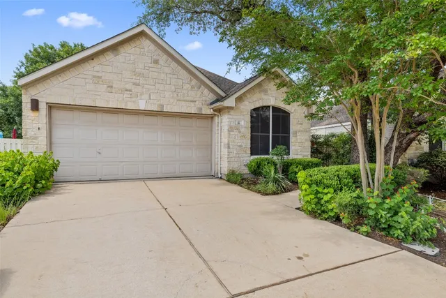 a front view of house with yard and trees around