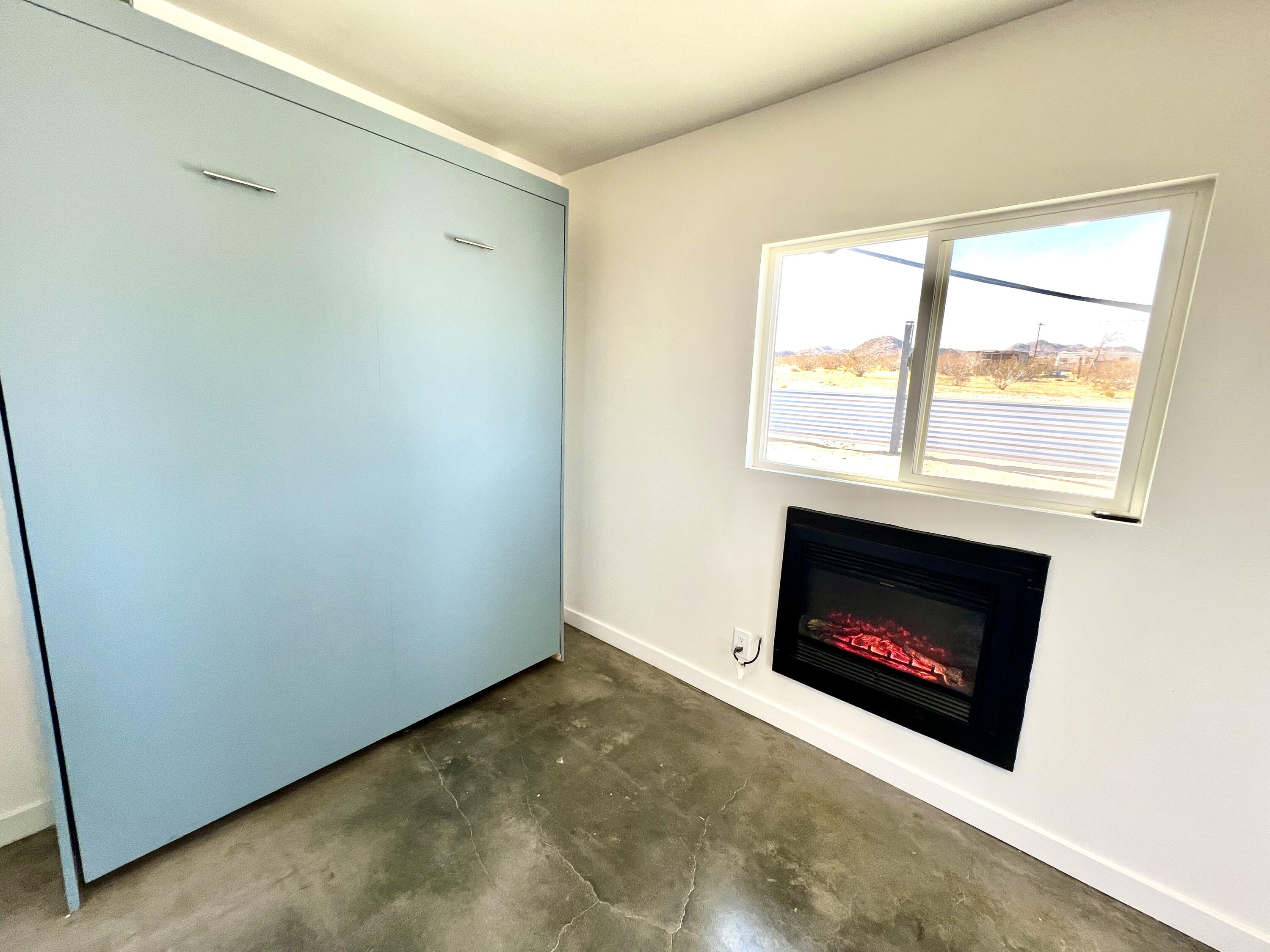 2774 Kickapoo Trail Landers, CA 92285 - Photo 12 of 51 a room with a fireplace and a fireplace
