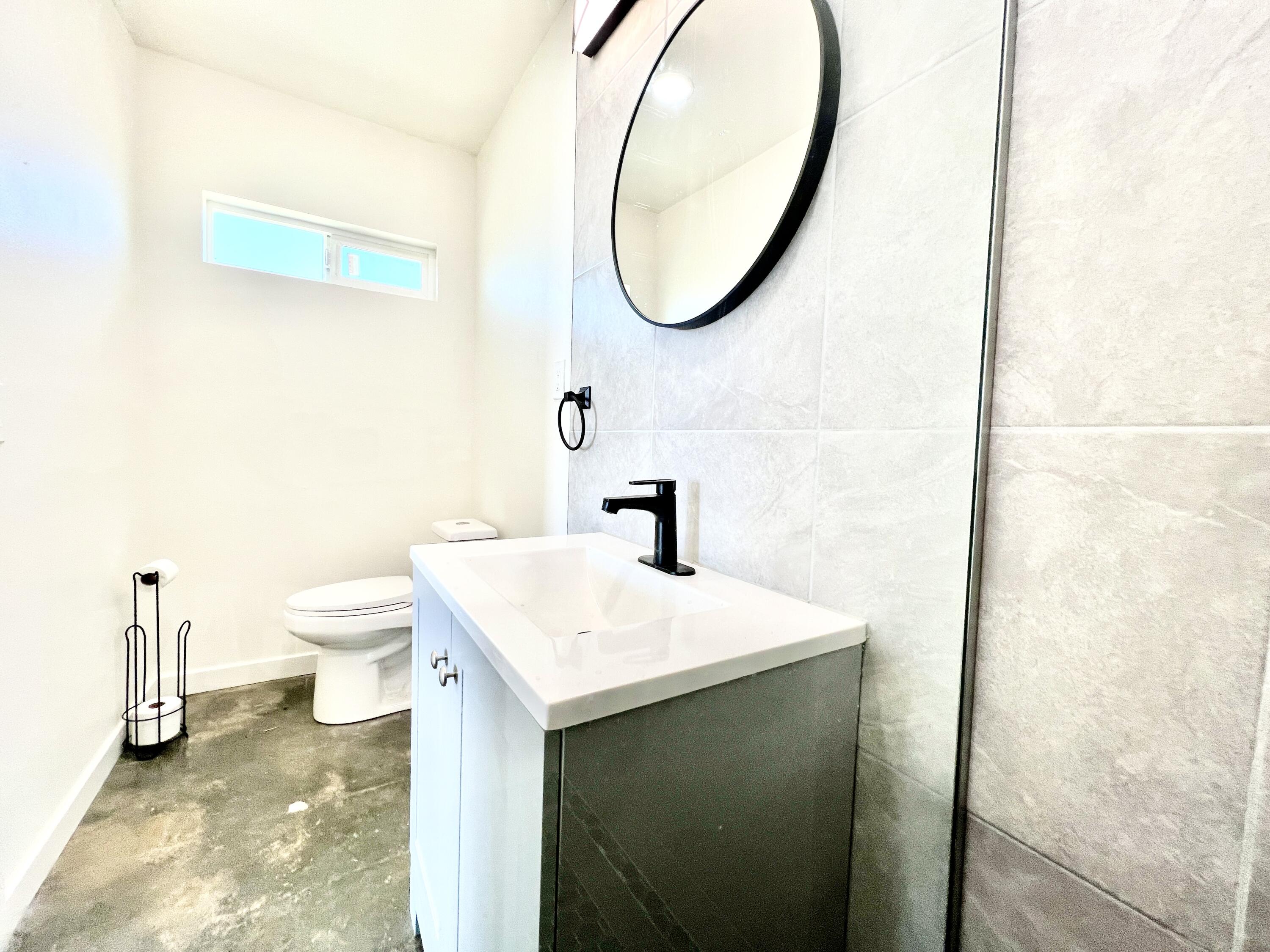 2774 Kickapoo Trail Landers, CA 92285 - Photo 15 of 51 a bathroom with a sink a toilet and a mirror