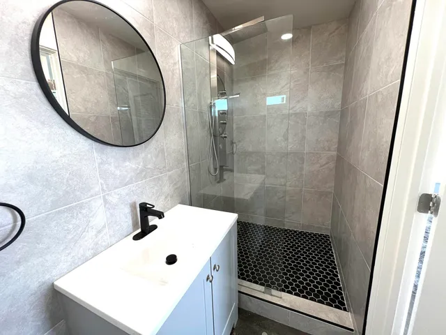 a bathroom with a sink a toilet and a mirror