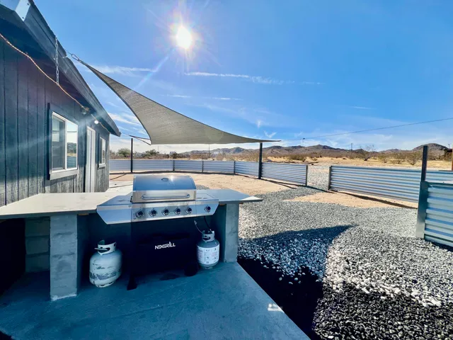 a view of a terrace with lawn chairs