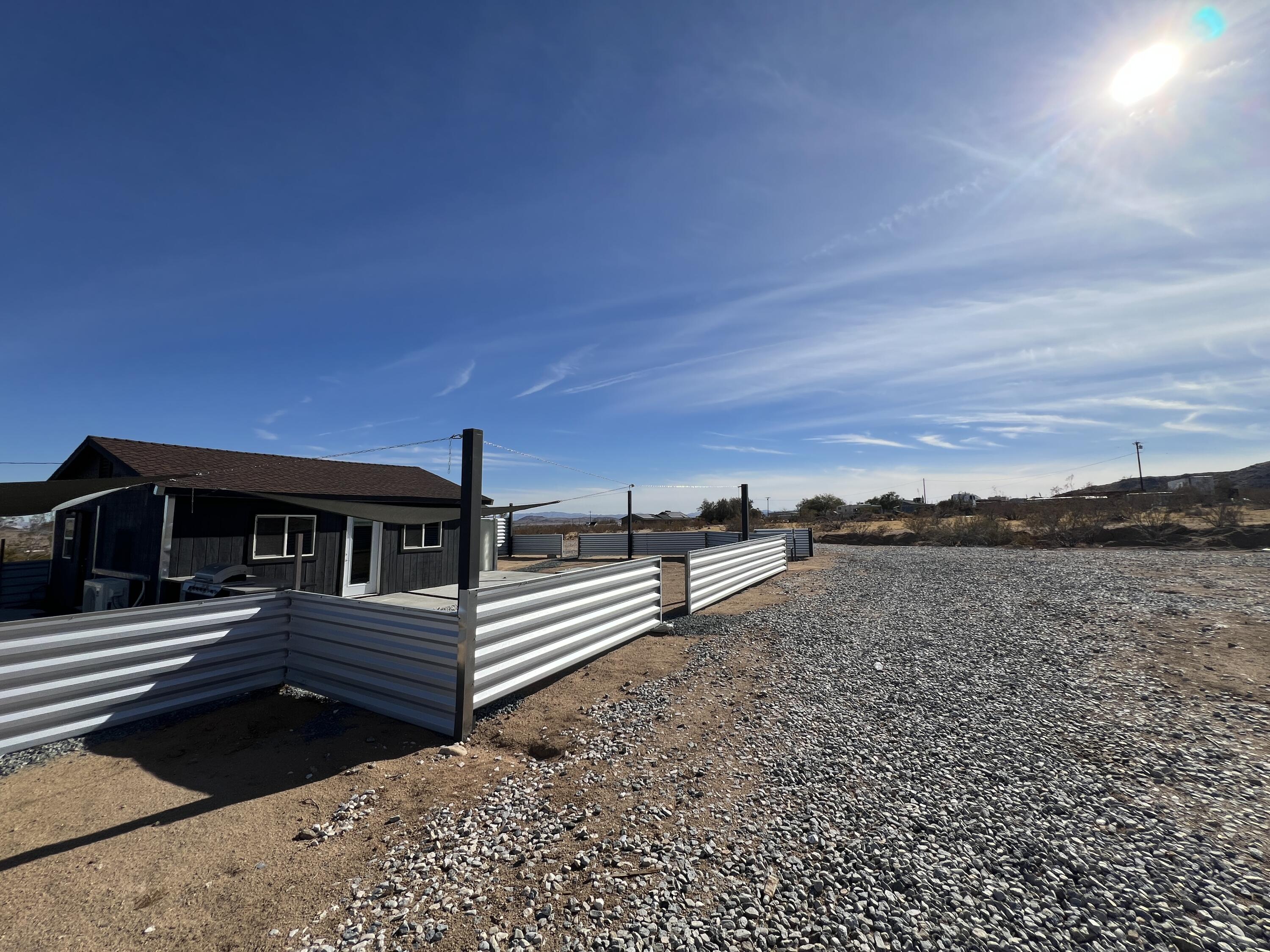 2774 Kickapoo Trail Landers, CA 92285 - Photo 41 of 51 a view of a roof deck with wooden floor and fence