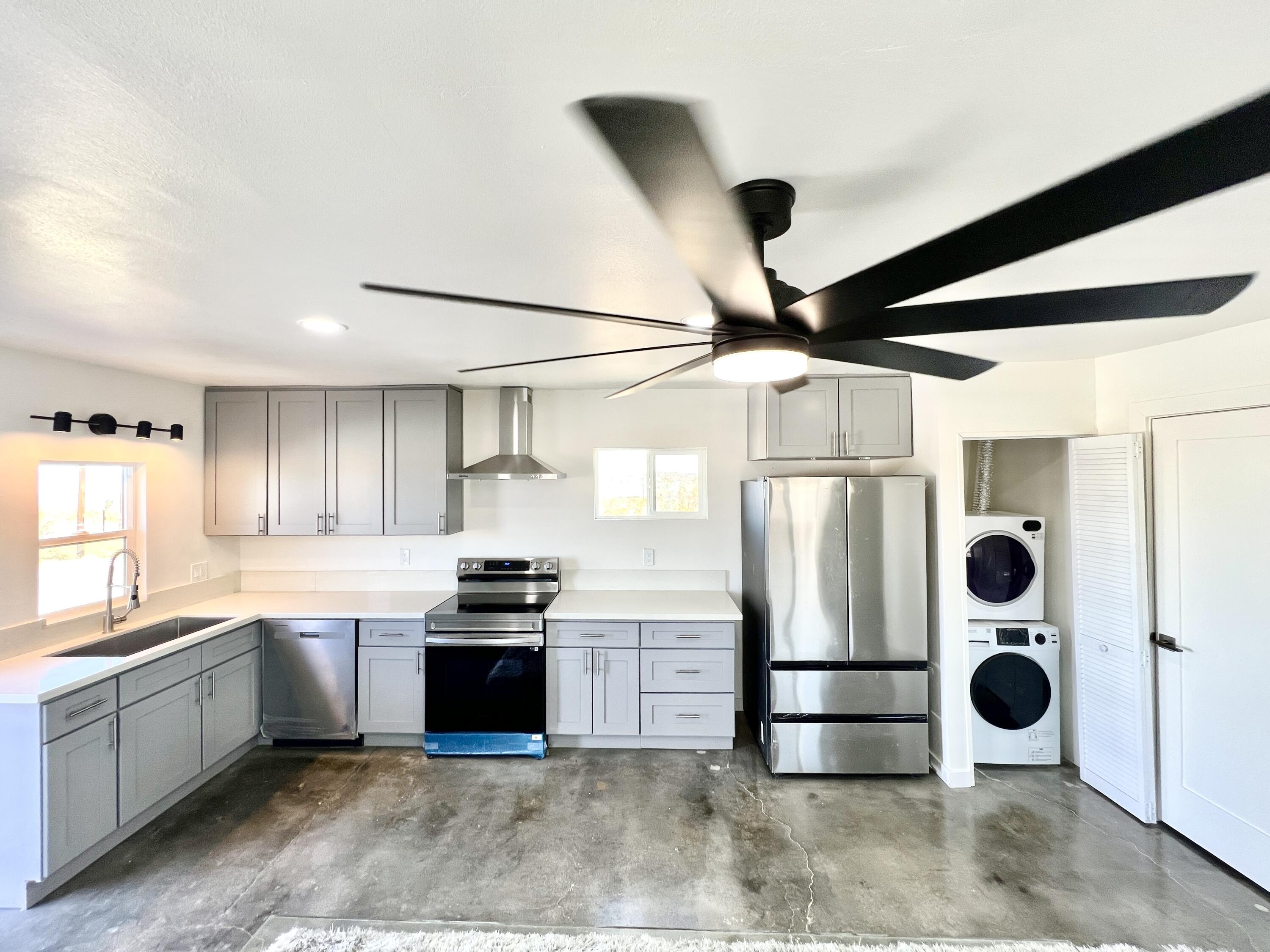 2774 Kickapoo Trail Landers, CA 92285 - Photo 6 of 51 a kitchen with stainless steel appliances granite countertop a stove a refrigerator and a sink