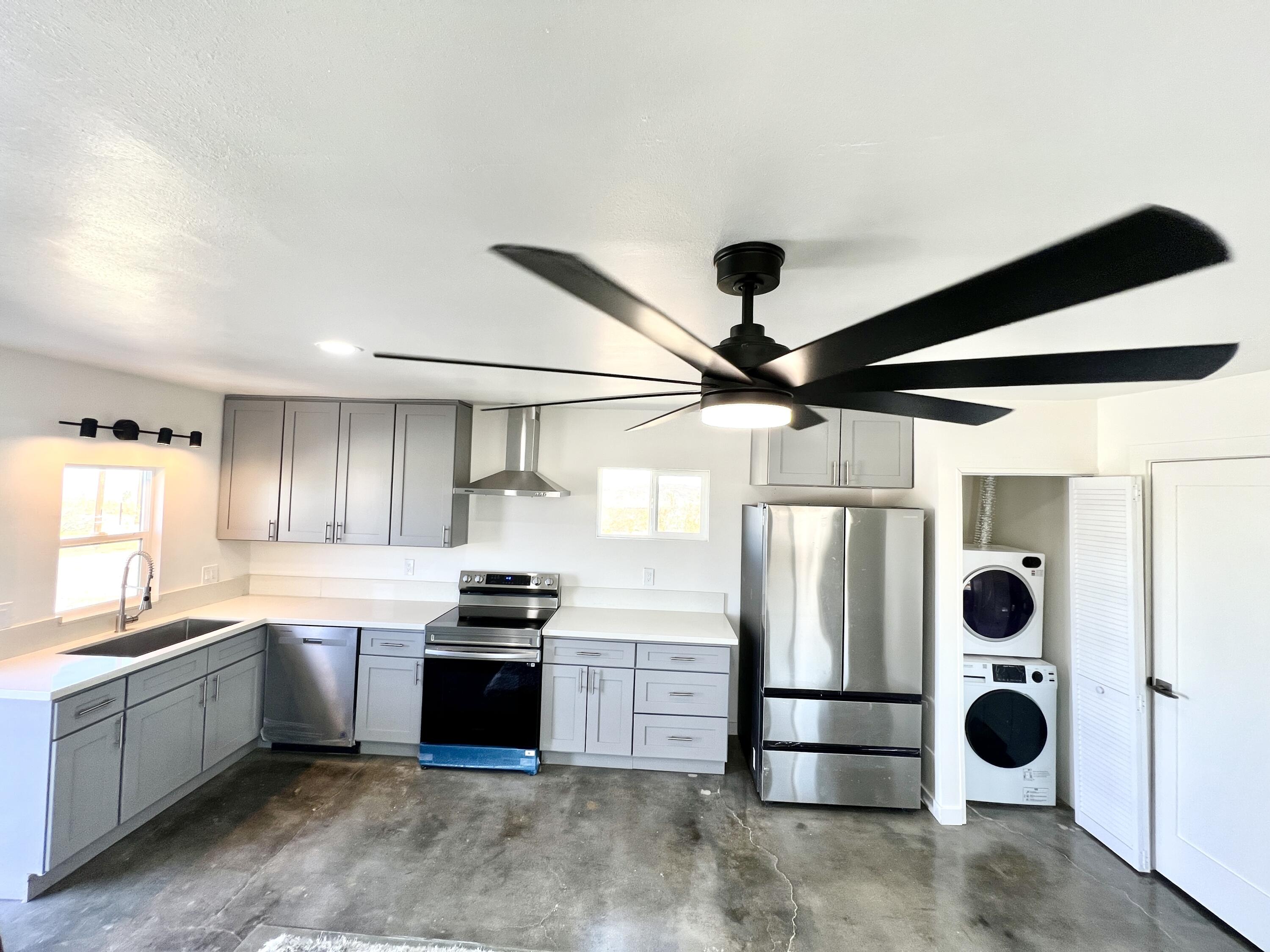 2774 Kickapoo Trail Landers, CA 92285 - Photo 7 of 51 a kitchen with stainless steel appliances granite countertop a refrigerator and a sink