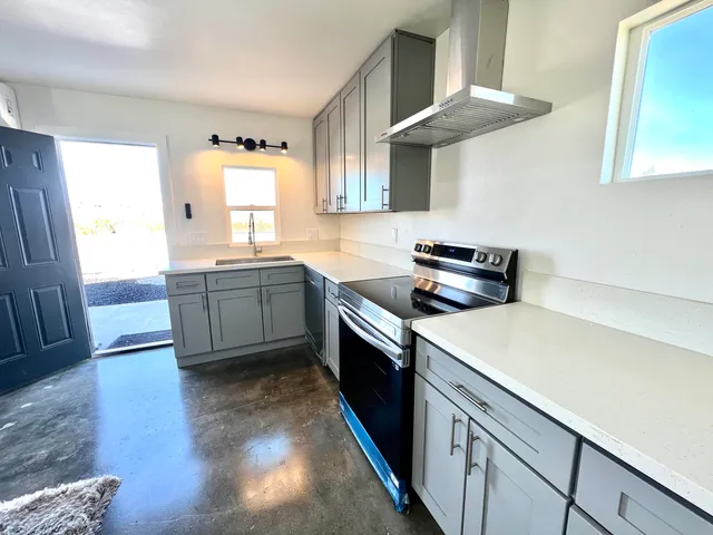 a kitchen with stainless steel appliances a sink stove and cabinets