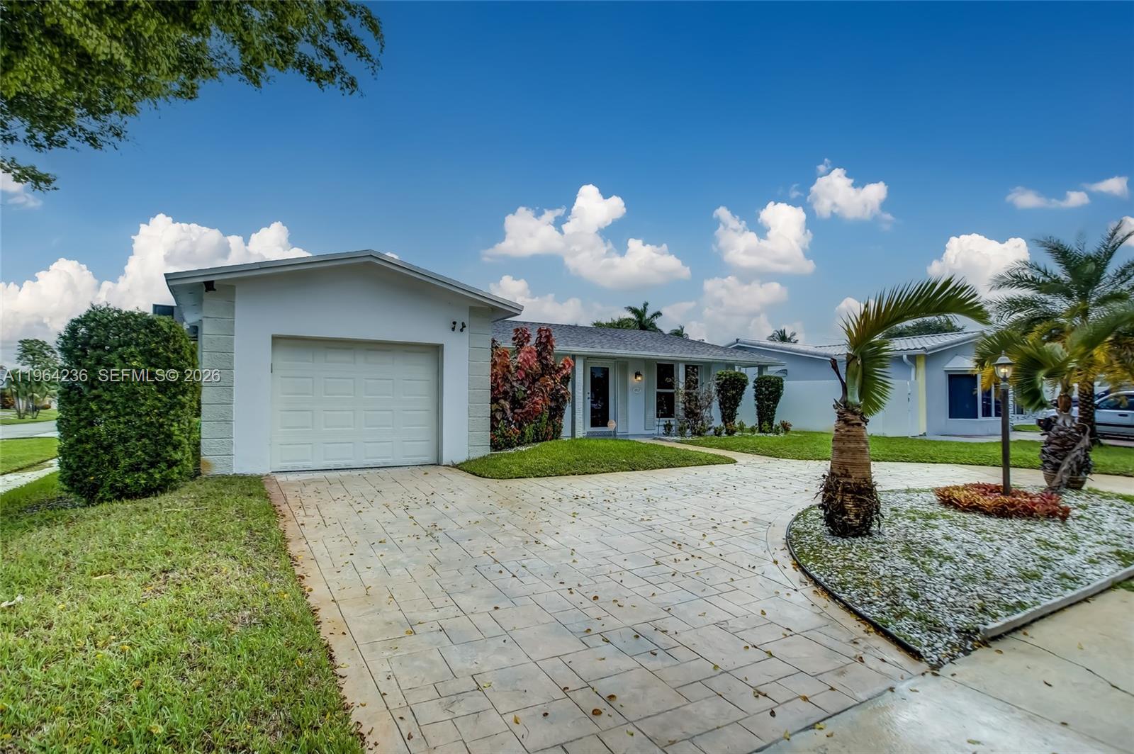 4917 West Park Road Hollywood, FL 33021 - Photo 1 of 25 a front view of a house with garden