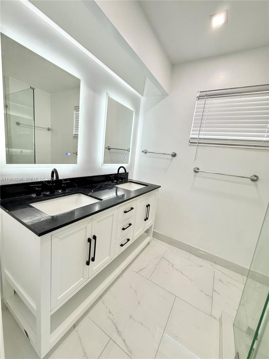 4917 West Park Road Hollywood, FL 33021 - Photo 13 of 25 a white kitchen with a sink and cabinets