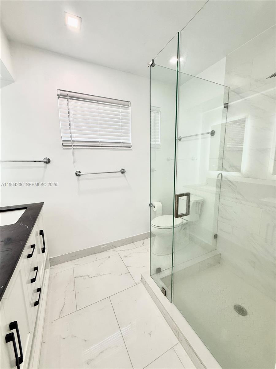 4917 West Park Road Hollywood, FL 33021 - Photo 14 of 25 a bathroom with a shower and a sink