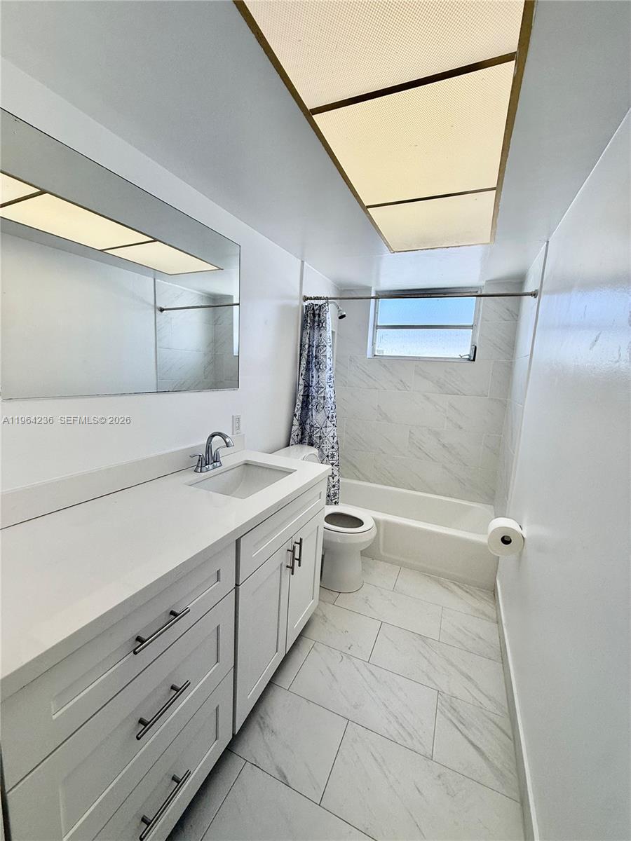 4917 West Park Road Hollywood, FL 33021 - Photo 17 of 25 a bathroom with a granite countertop sink a toilet and vanity