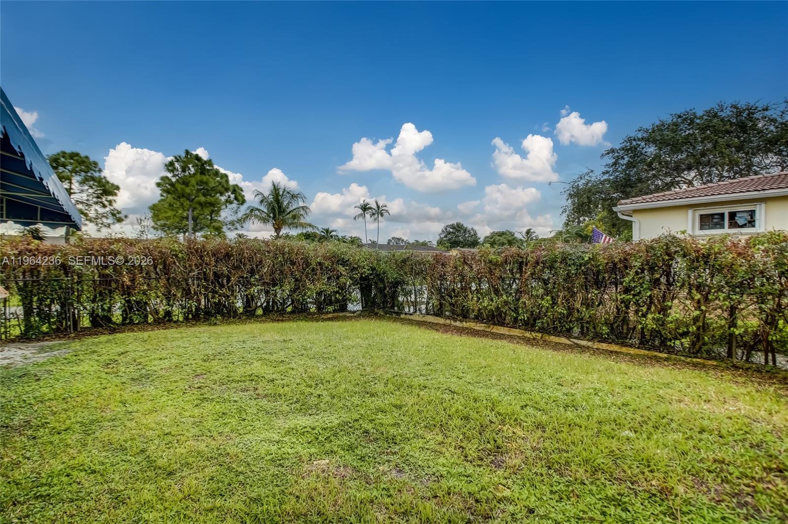 4917 West Park Road Hollywood, FL 33021 - Photo 20 of 25 a backyard of a house with lots of green space